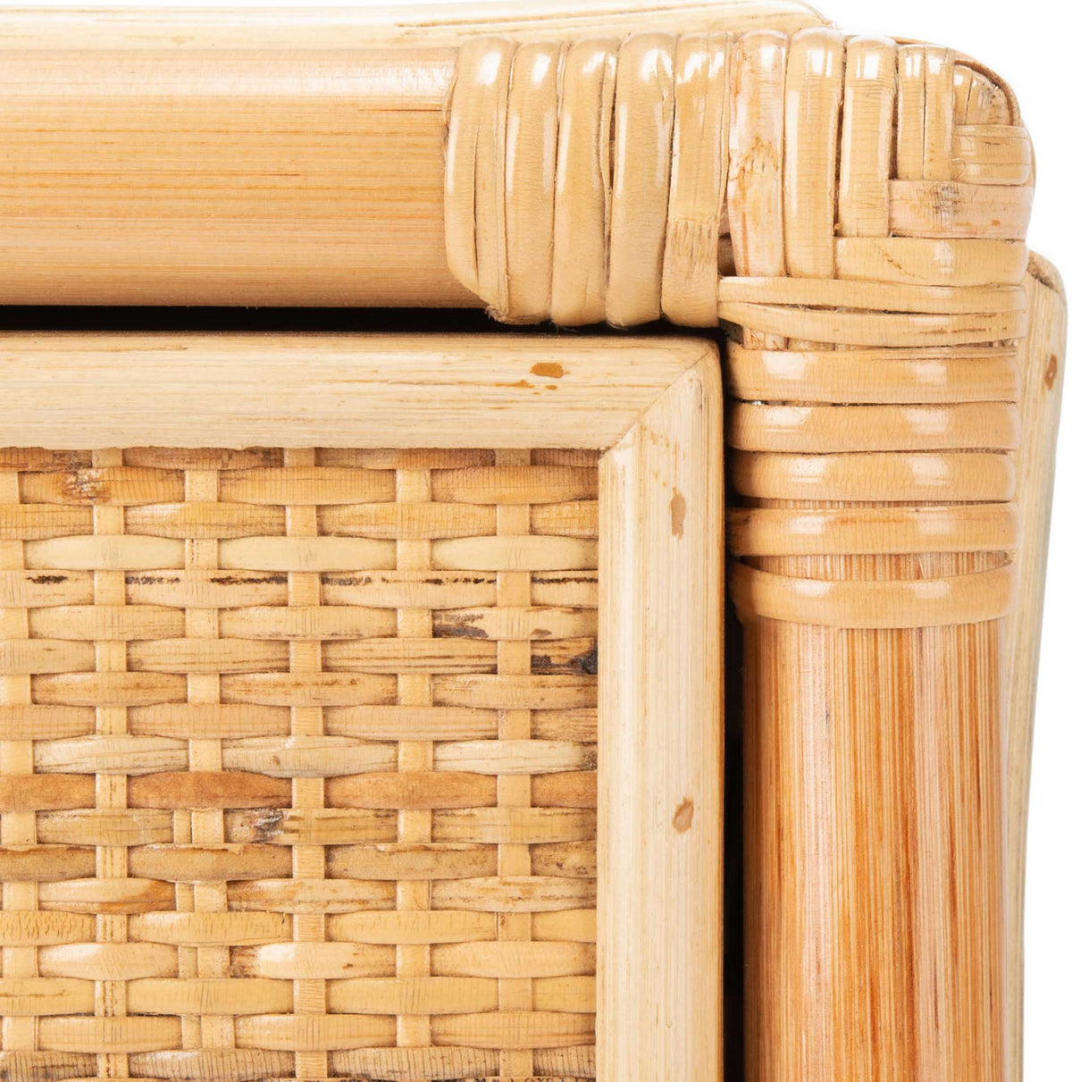 Wrapped cane joints meet the pale natural wood frame beside a woven cane panel