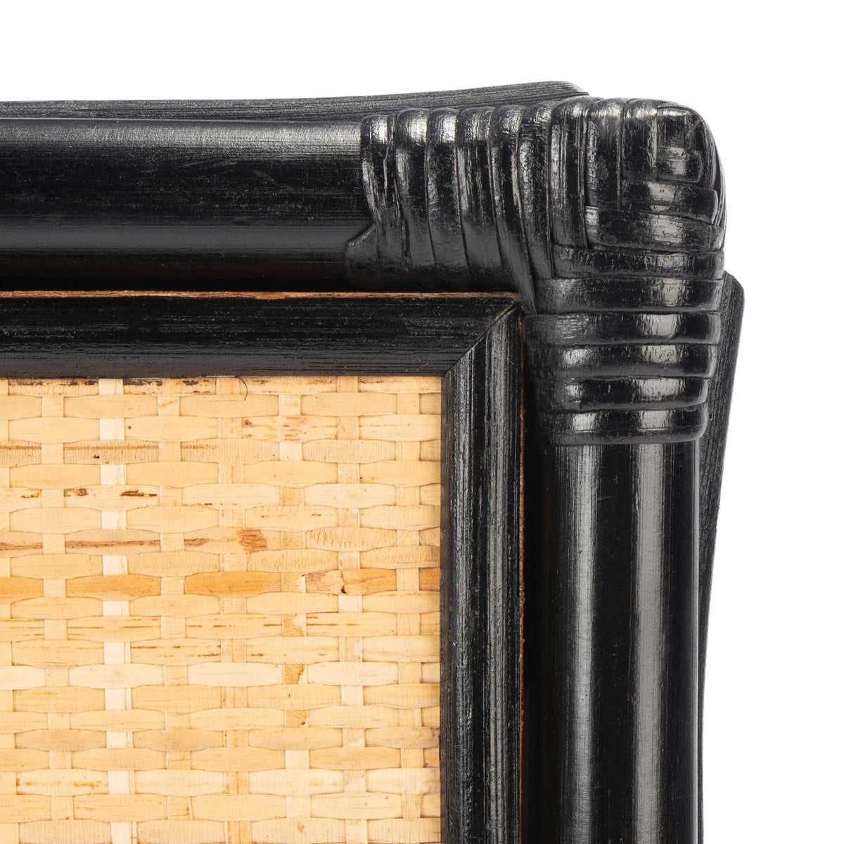 Wrapped black corner detailing frames the warm, natural cane panel