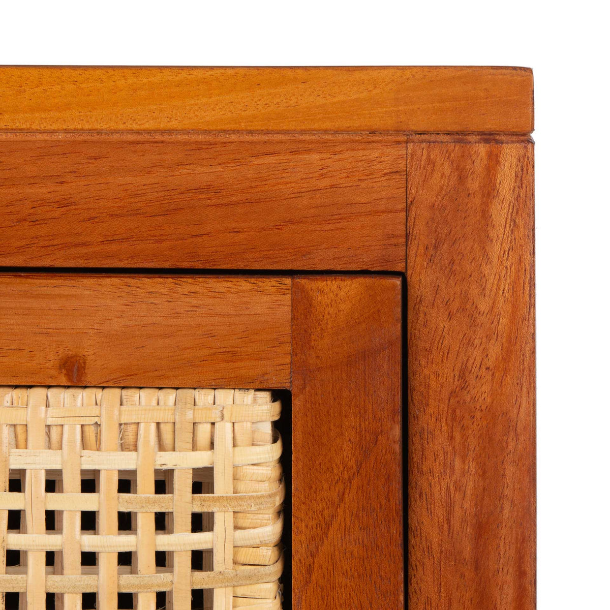 Honey-toned wood grain frames the airy natural cane weave on the drawer front.