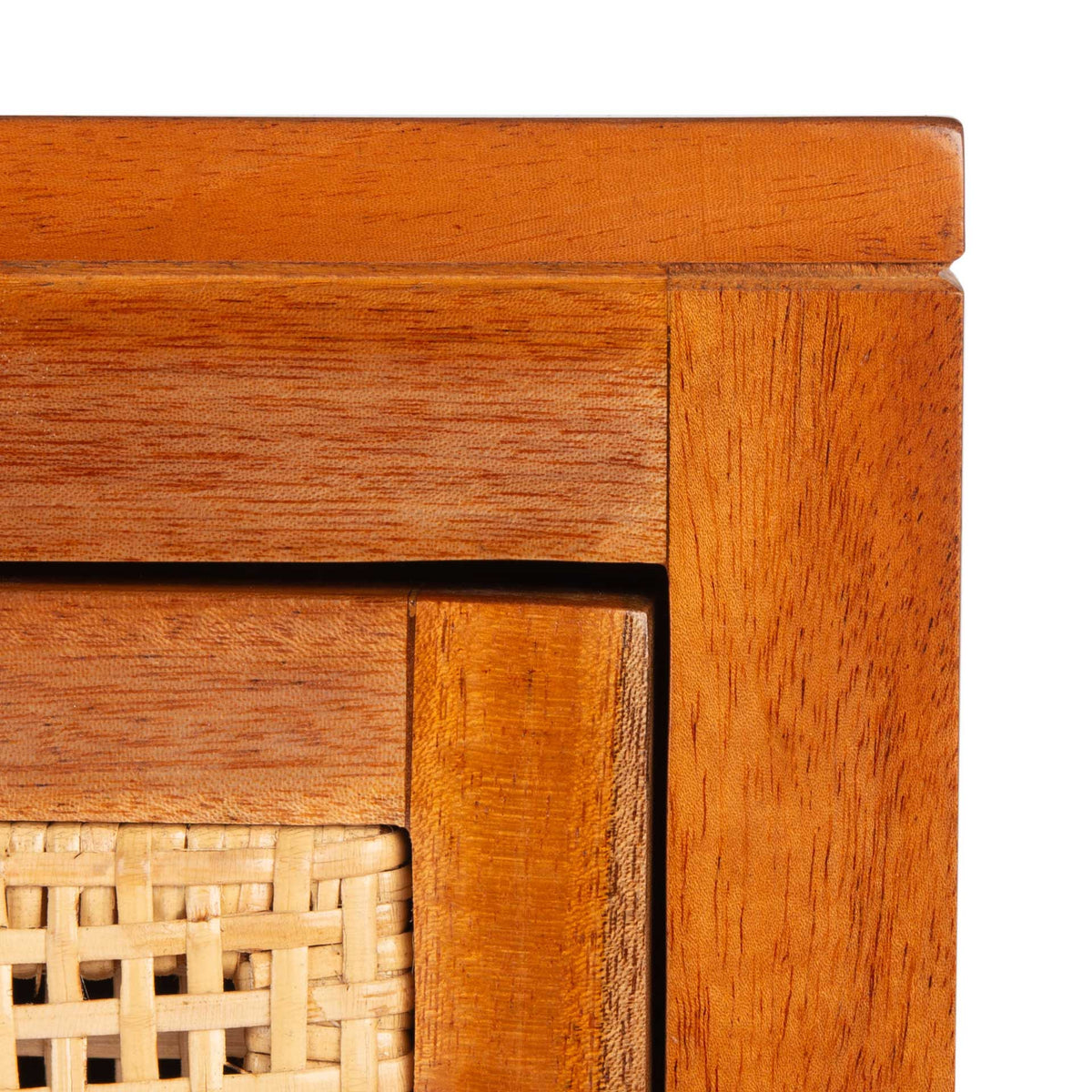 Warm wood grain and natural cane weaving add rich texture to the nightstand