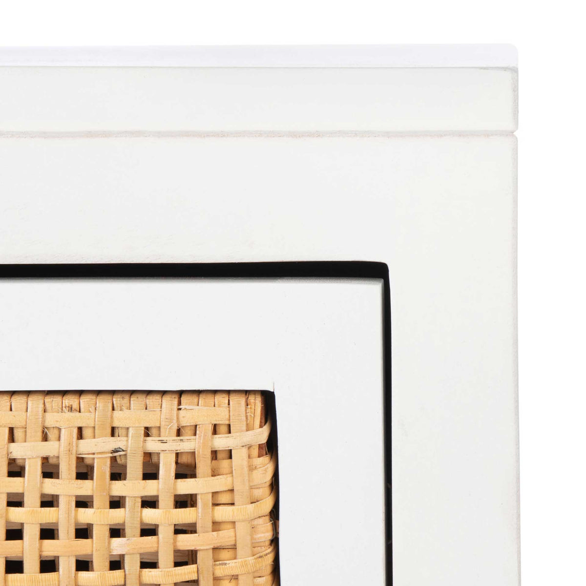 White wood trim highlights the natural cane weave on the drawer panel
