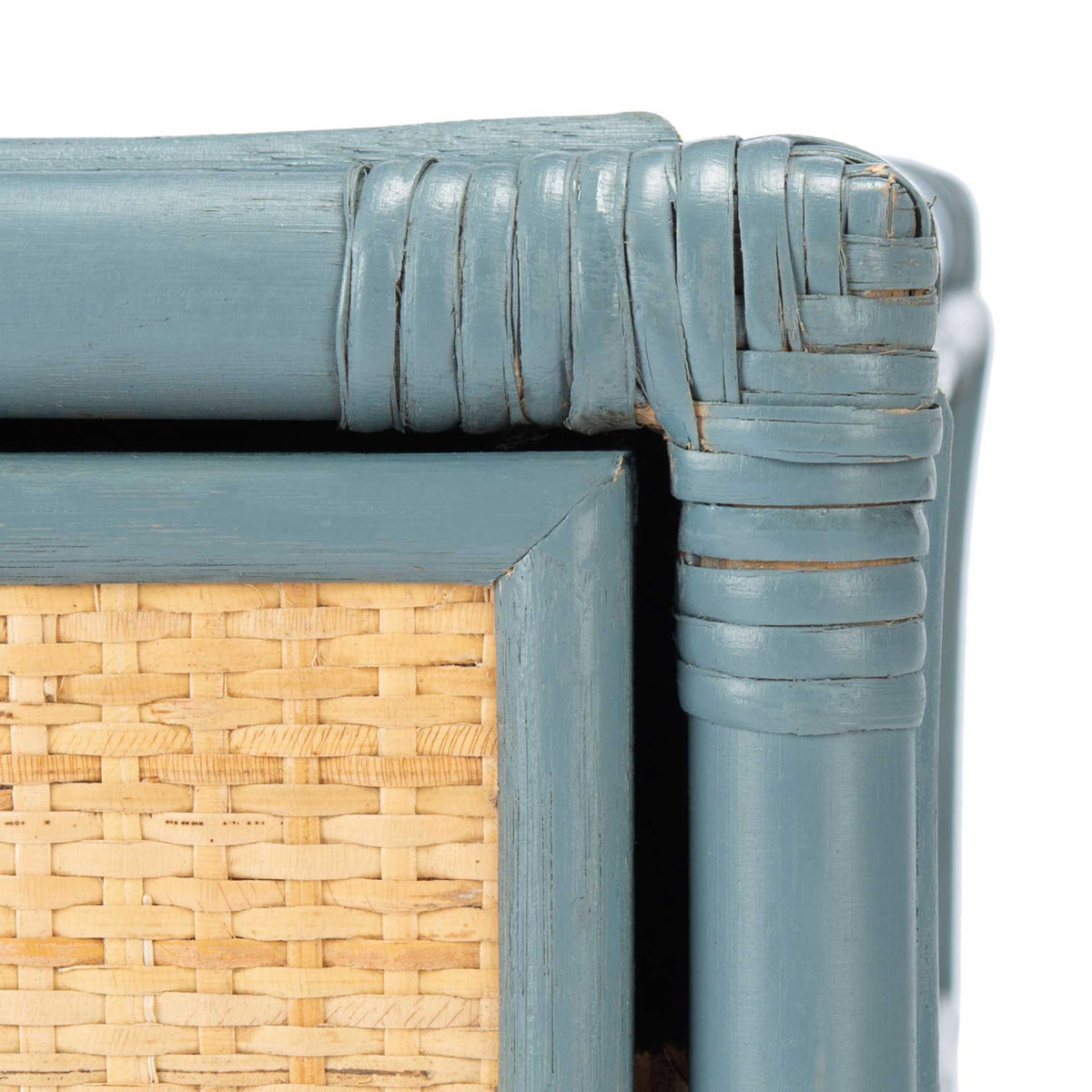 Wrapped blue-gray corner trim shows subtle distressing beside the natural weave