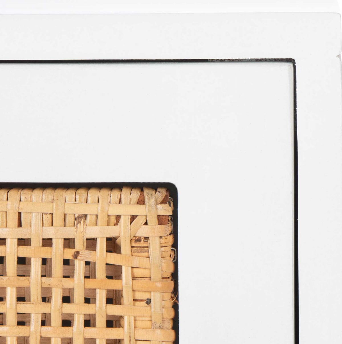 Natural woven cane brings texture to the crisp white drawer frame.