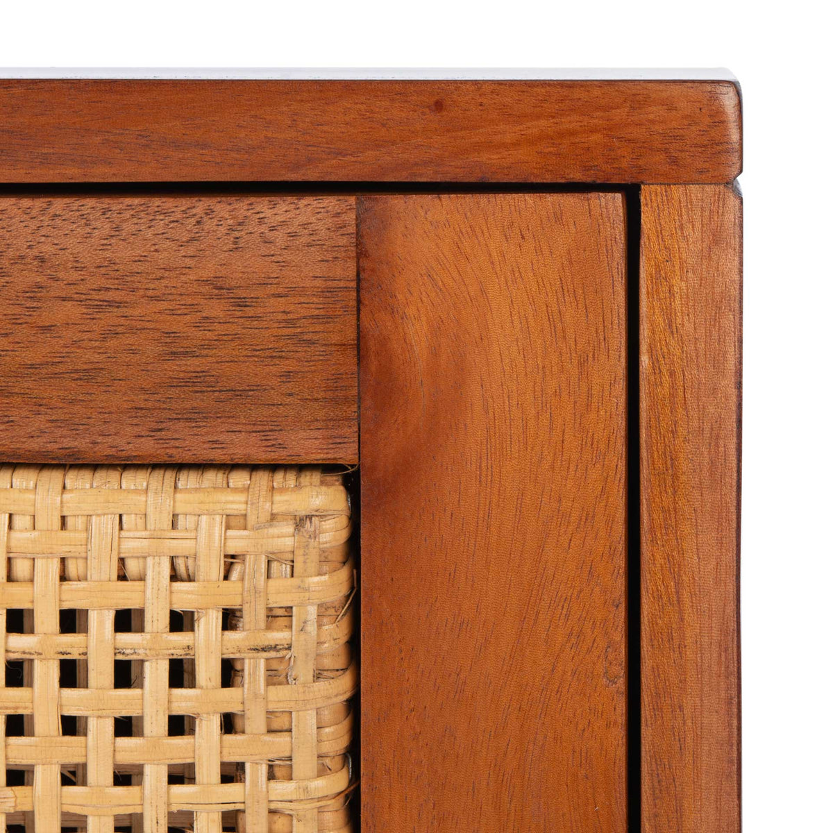The tightly woven cane inset contrasts with the warm grain of the wooden drawer frame.