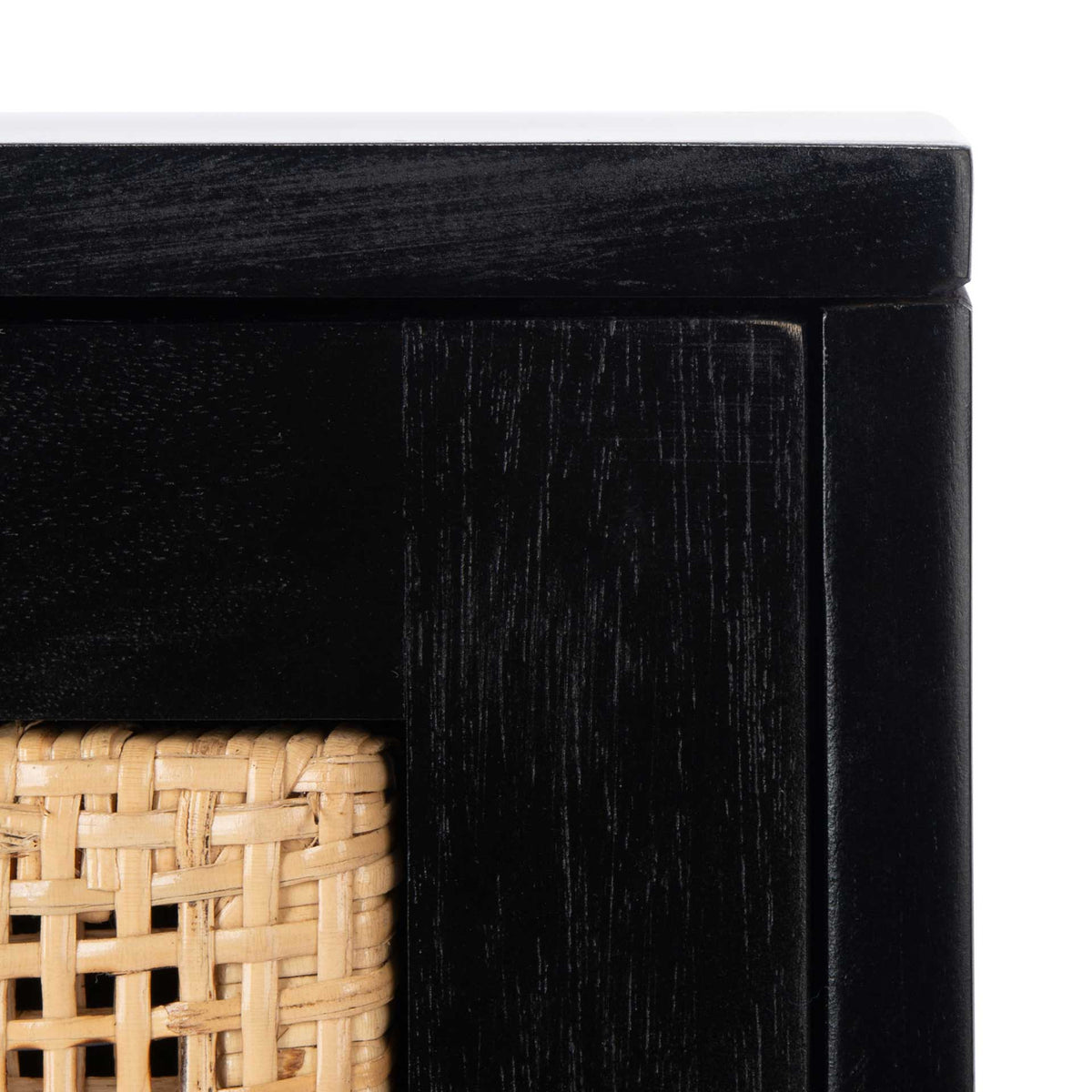Natural woven cane contrasts with the black wood frame and its crisp edges.