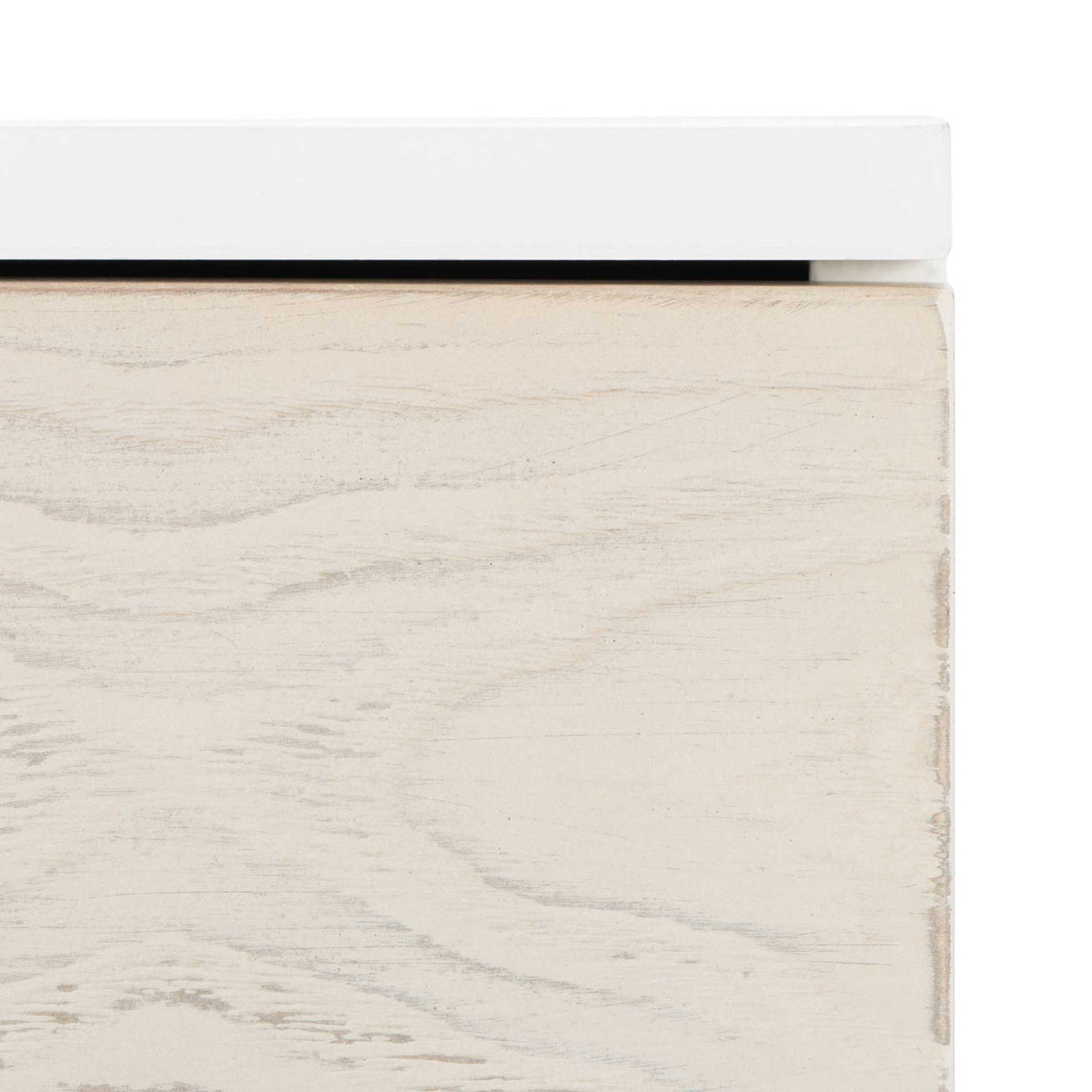 Subtle wood grain in a whitewashed drawer front contrasts with the crisp white tabletop.