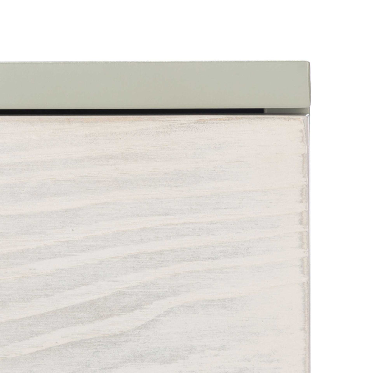 A soft gray top frames the light wood grain on a whitewashed drawer front.