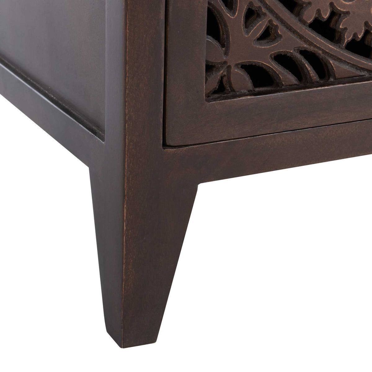 A tapered brown leg supports the cabinet beneath its floral openwork door