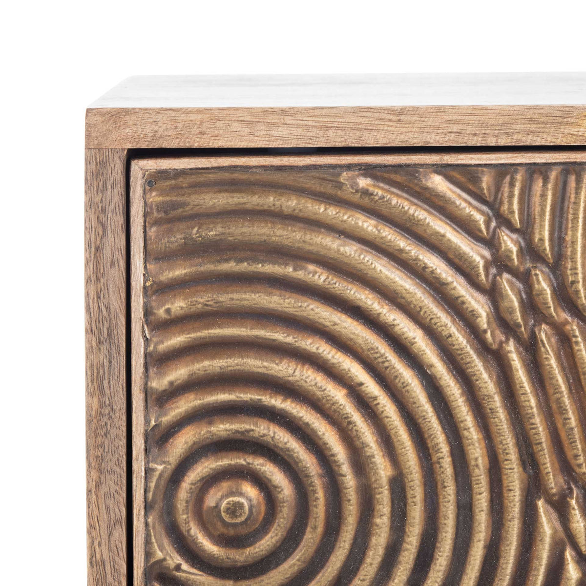 Raised concentric grooves give the brass-toned drawer front a sculptural, tactile finish
