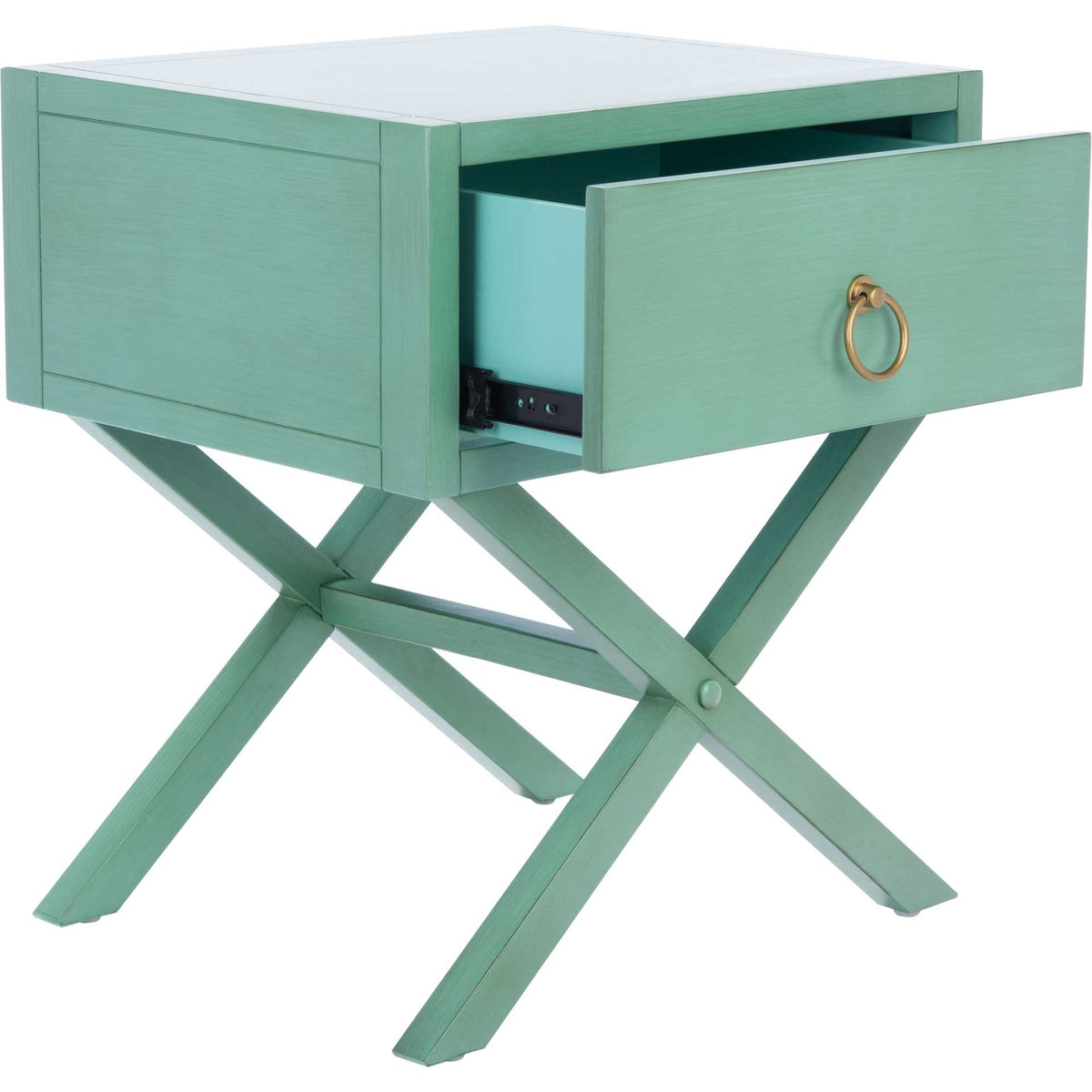 The turquoise drawer slides out above crossed legs, keeping bedside items within reach.