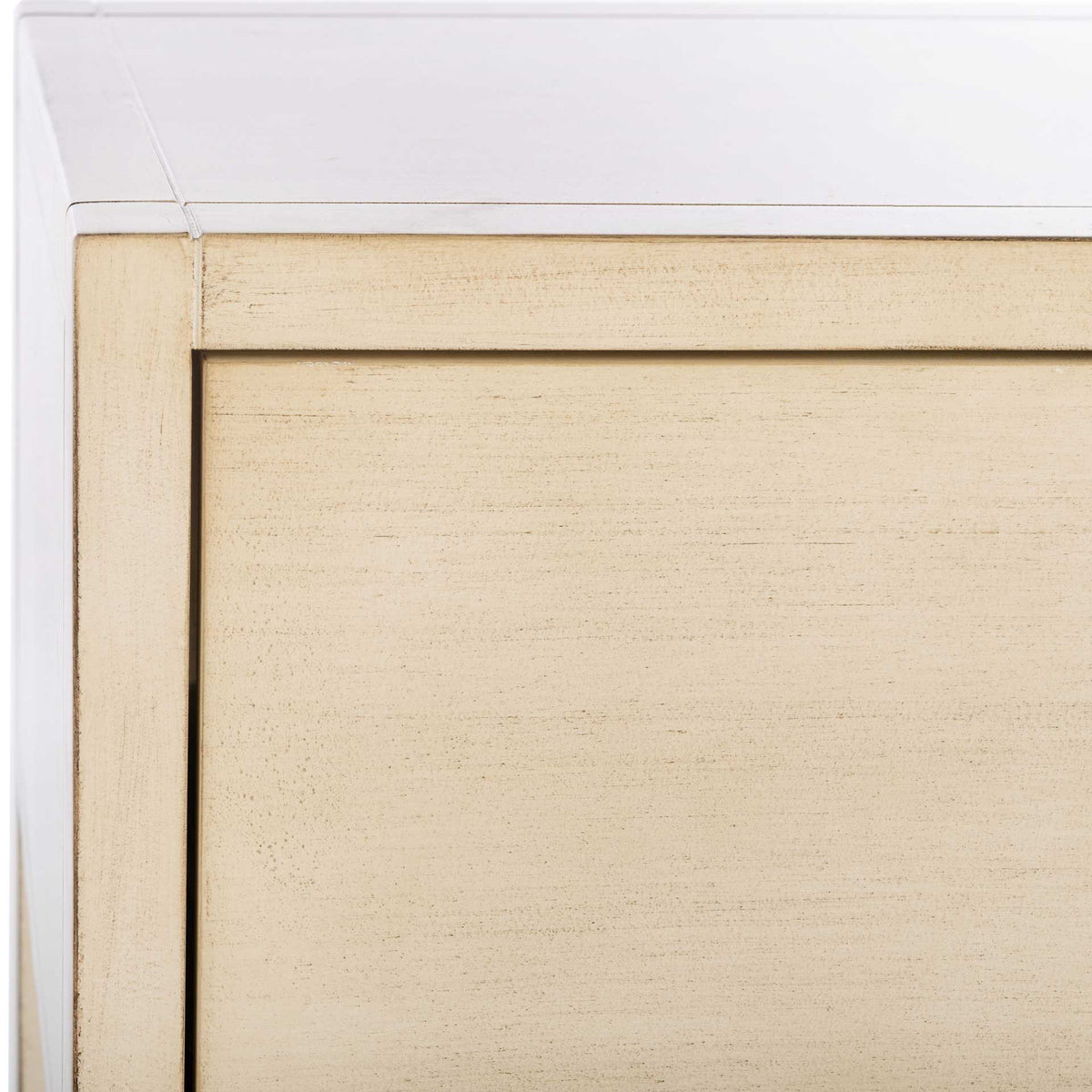 Subtle distressing lends texture to the antique white top edge and inset drawer front.