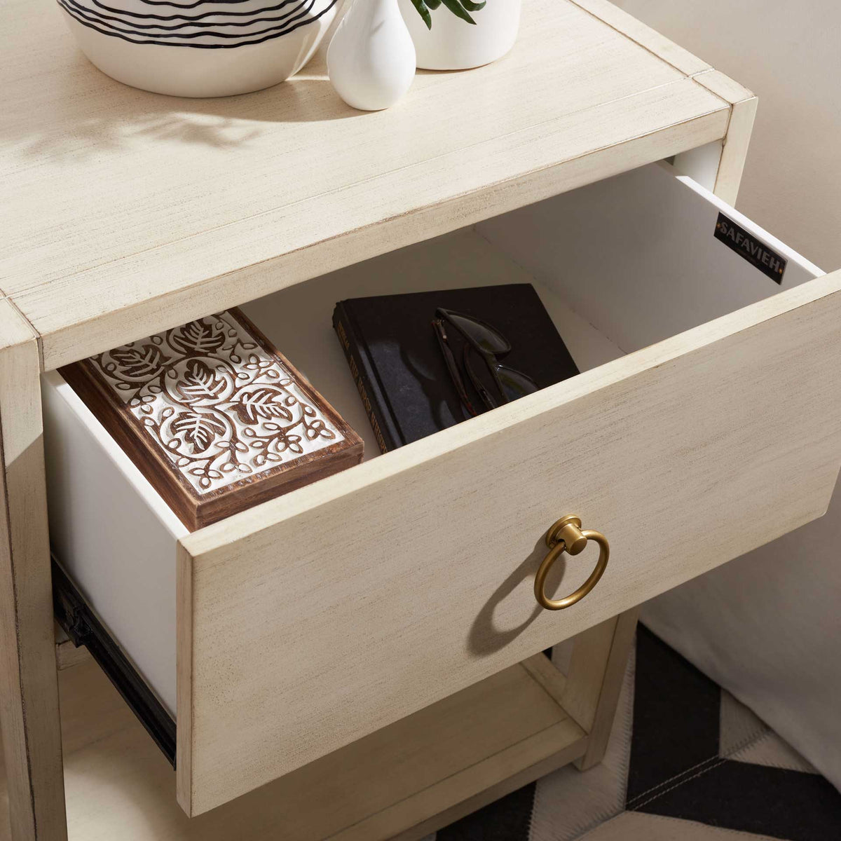A generously sized drawer keeps books and accessories organized beneath the smooth tabletop.
