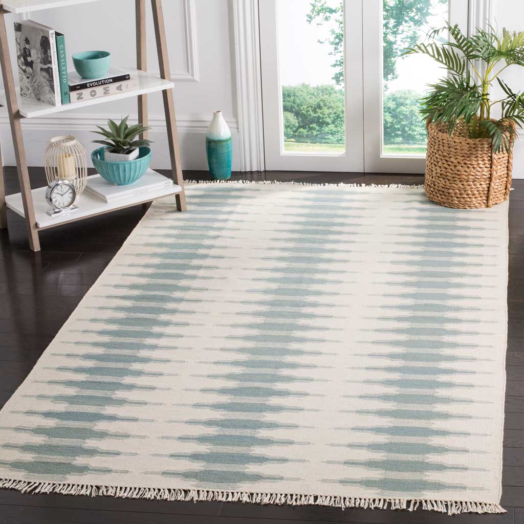 An ivory wool rug with blue brushstroke stripes brings relaxed color to a bright living space.
