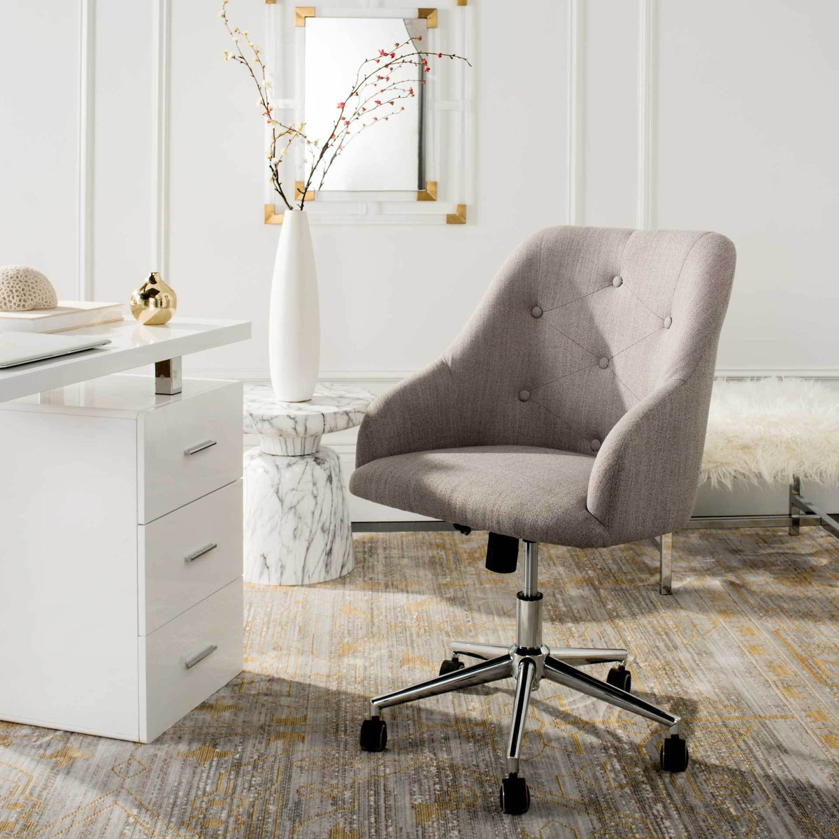 A plush gray linen desk chair brings tufted comfort and easy mobility to a workspace