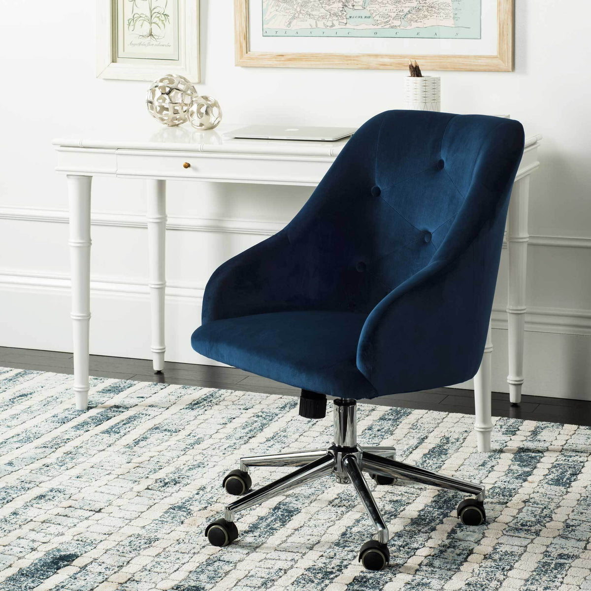 A tufted navy velvet desk chair adds rich color and rolling comfort to a bright workspace