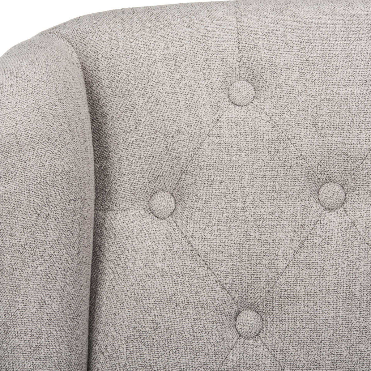 Fabric-covered buttons and diamond tufting bring depth and texture to the gray linen wingback