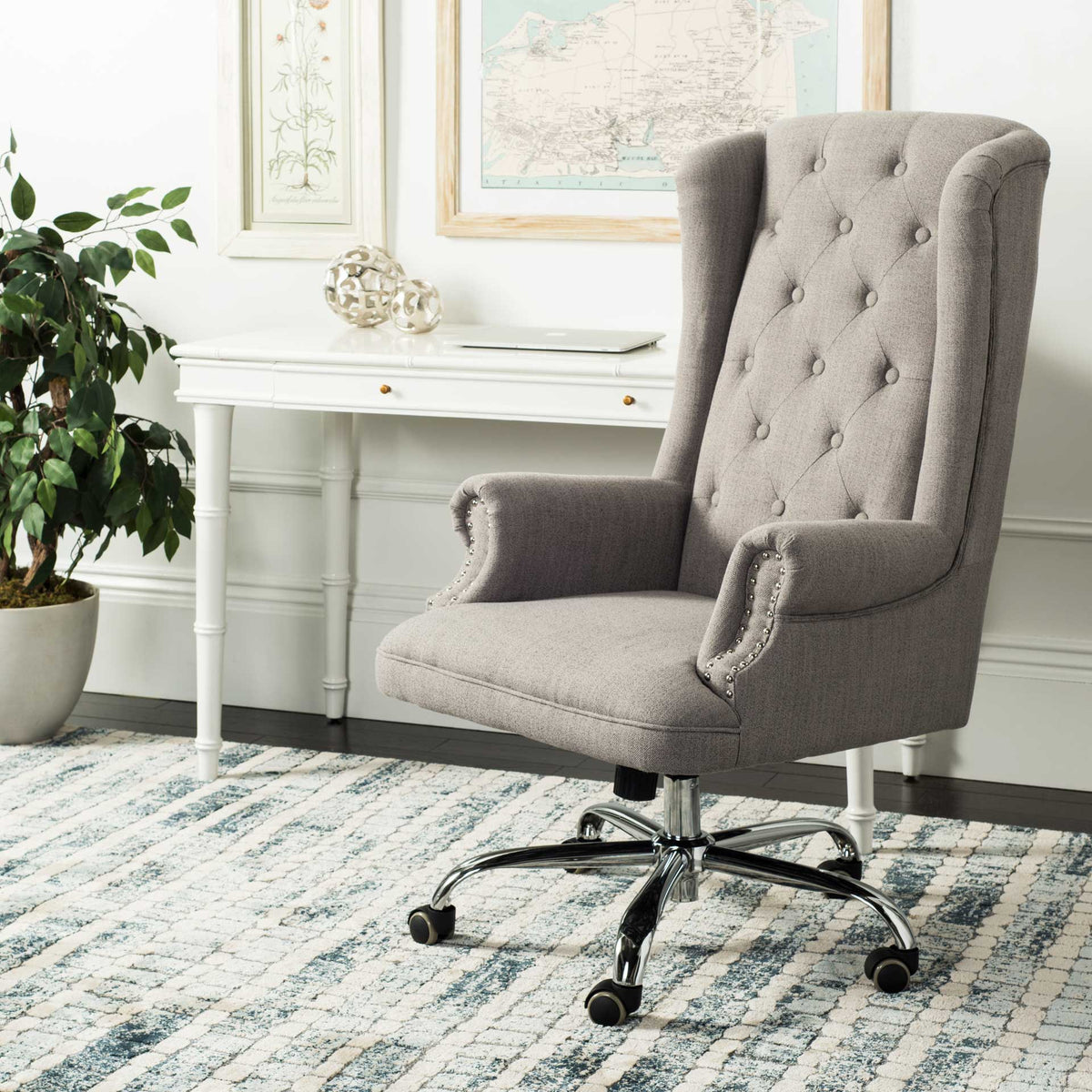 Gray tufted linen and nailhead-trimmed arms bring tailored comfort to a home office