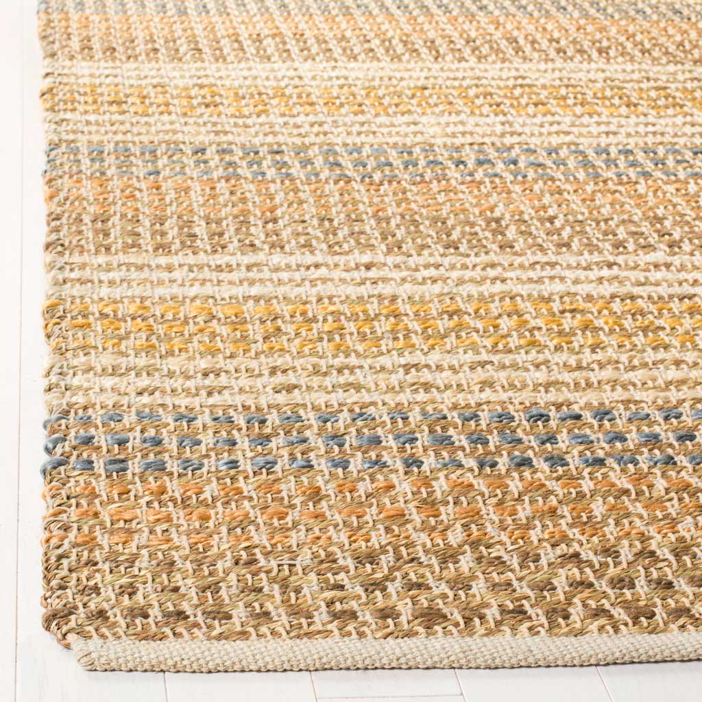 A neatly finished edge frames woven jute in warm neutrals with touches of blue and gold.