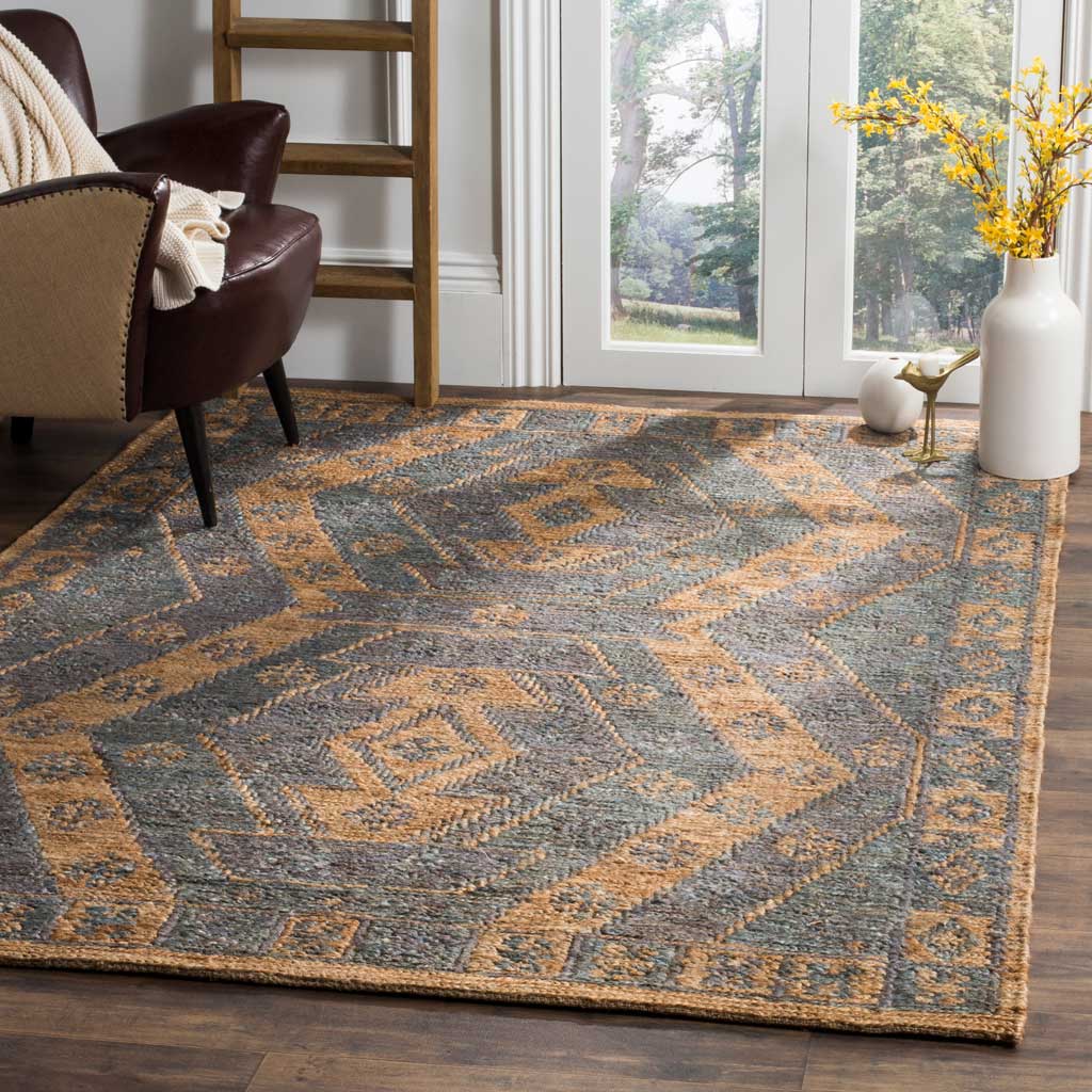 Slate and natural geometric jute rug anchors a cozy living space with its patterned border
