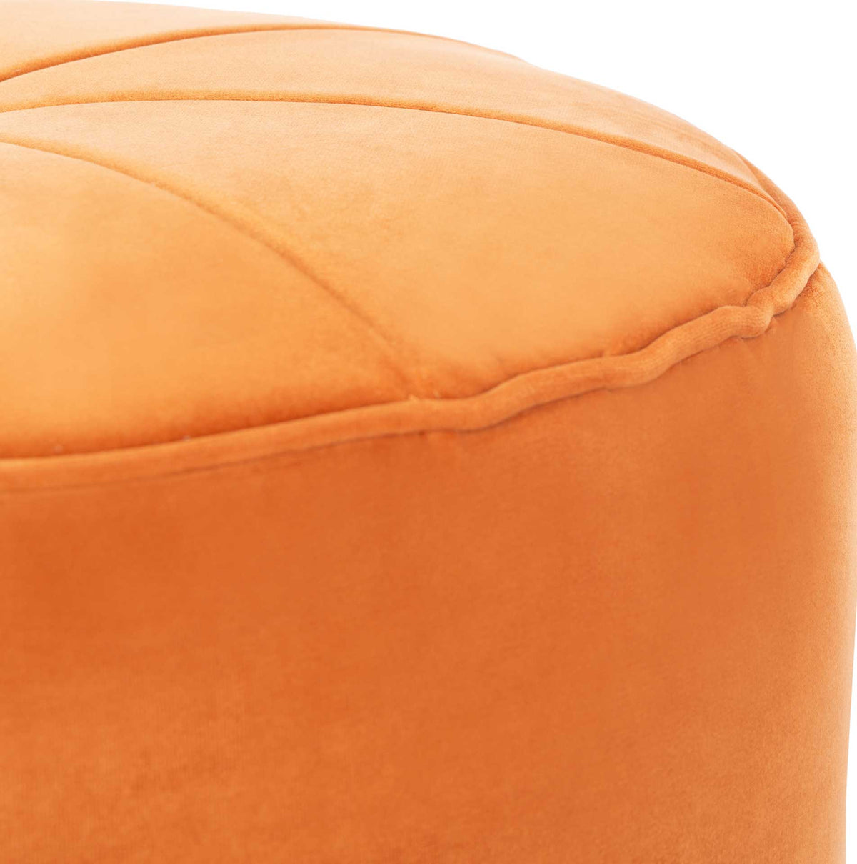 Piped trim frames the padded top, while stitched segments add dimension to the orange velvet.