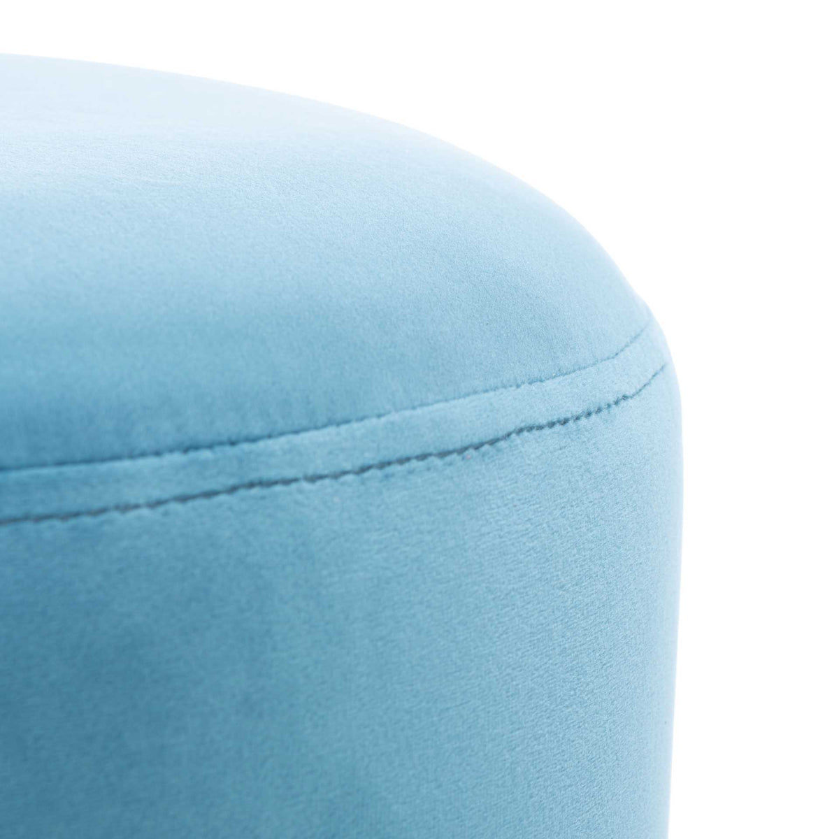 Soft blue velvet and a neat stitched seam lend the cushioned ottoman a tailored look.