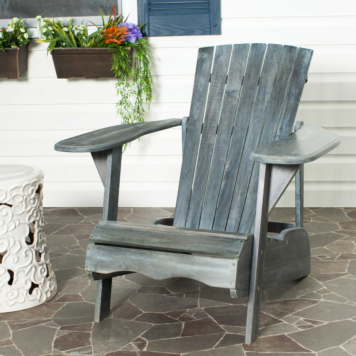Wide armrests and a reclined slatted back create an inviting patio perch in ash gray