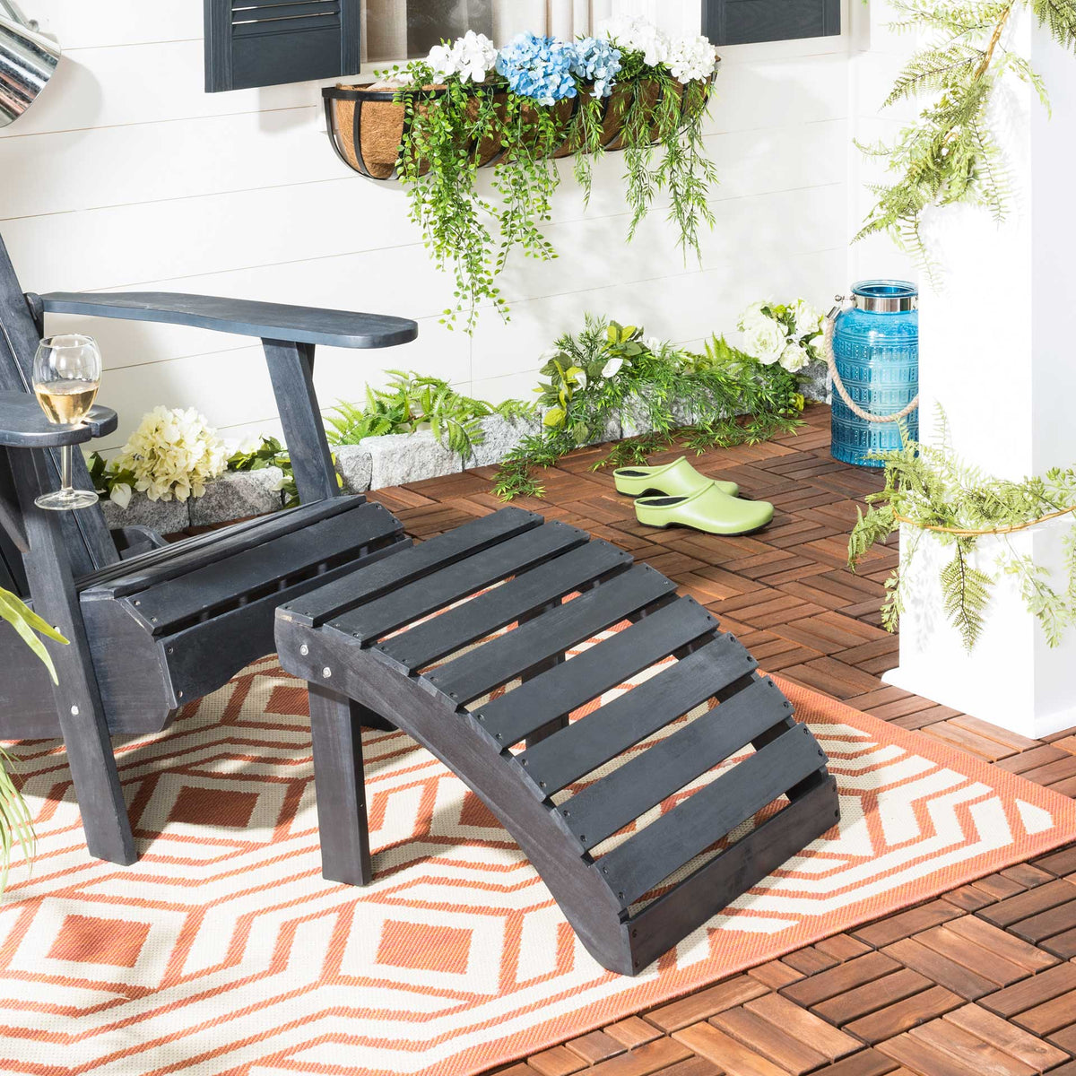 Dark slate gray slatted ottoman adds relaxed comfort beside a patio chair