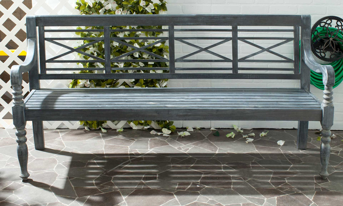 Ash gray lattice-back bench adds inviting seating to a tiled patio