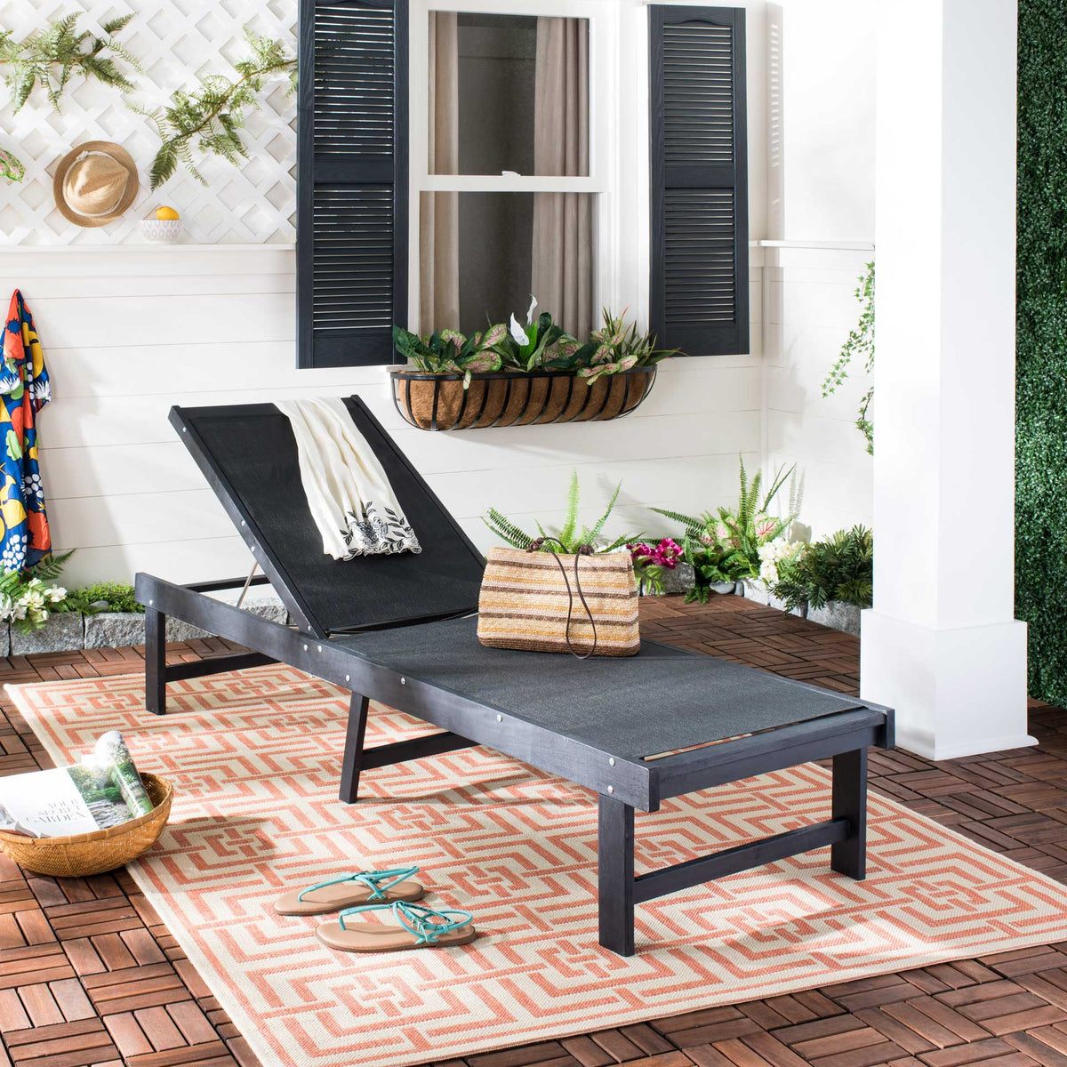 Dark slate gray acacia and breathable mesh bring streamlined comfort to a patterned patio.