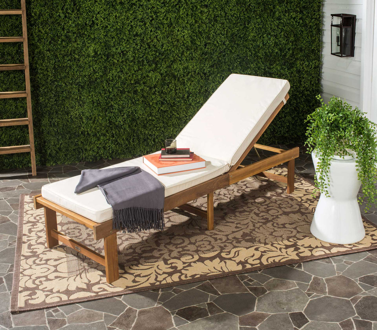 A beige cushion and honey-toned wood create an inviting outdoor spot to lounge.