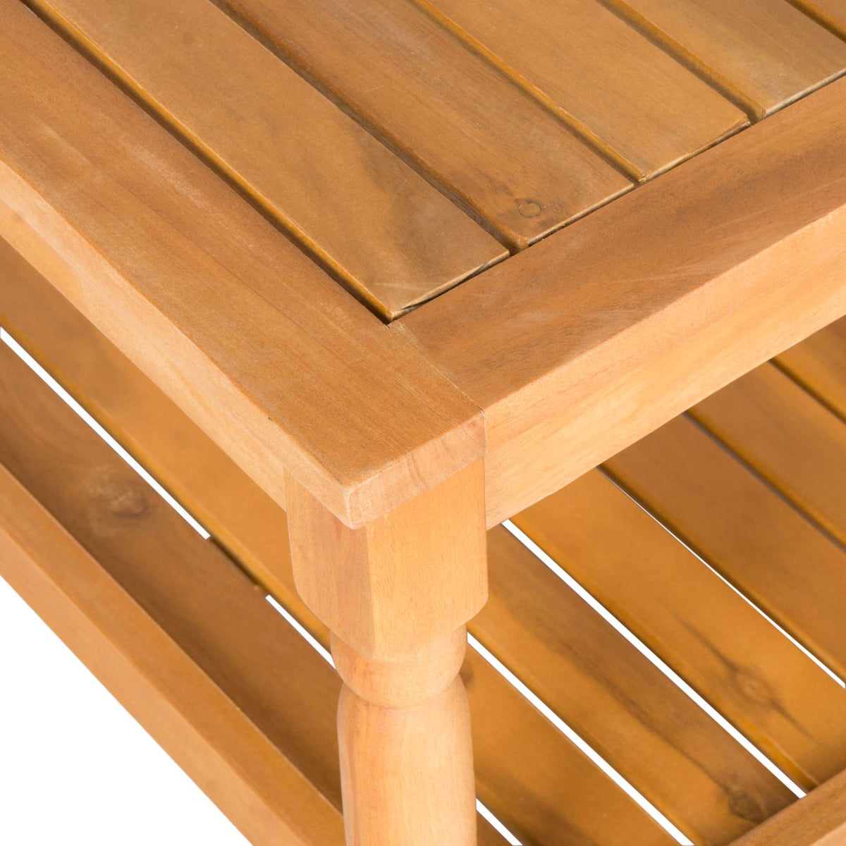 Golden acacia wood grain brings warmth to the slatted tabletop and smoothly turned corner leg.