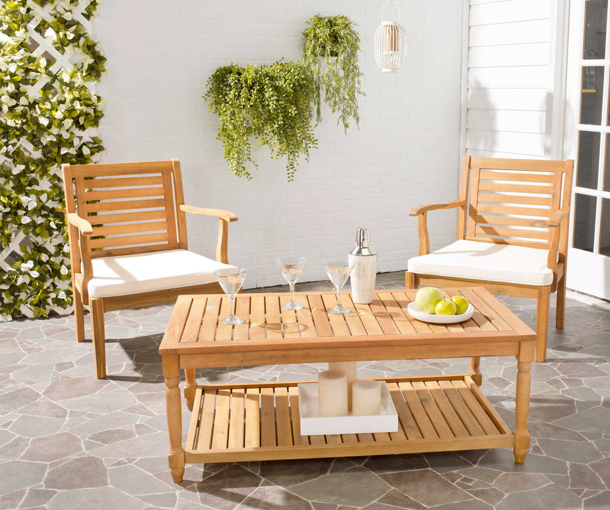 Natural acacia coffee table offers a slatted surface and handy shelf for relaxed outdoor living.