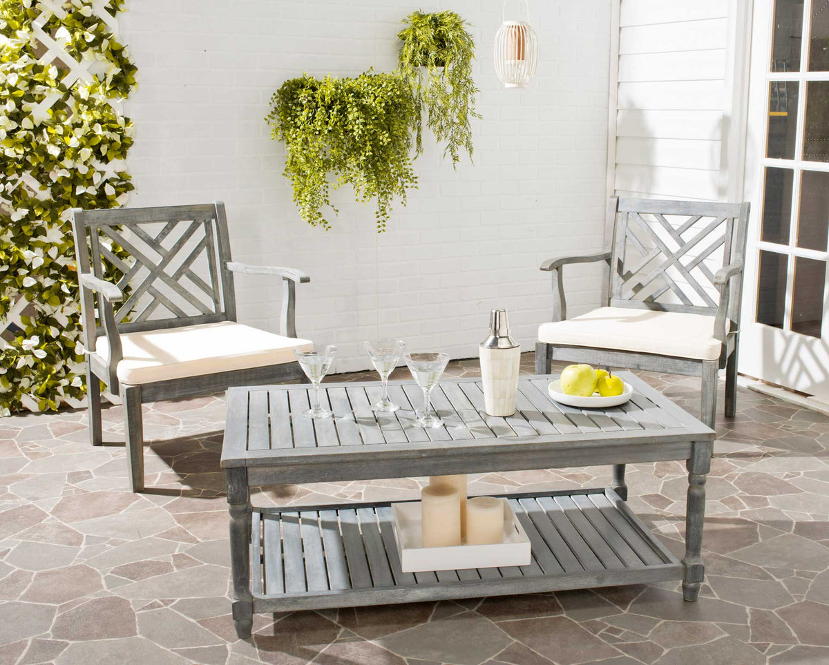 An ash gray coffee table adds slatted surfaces and handy shelf space to a patio seating area.