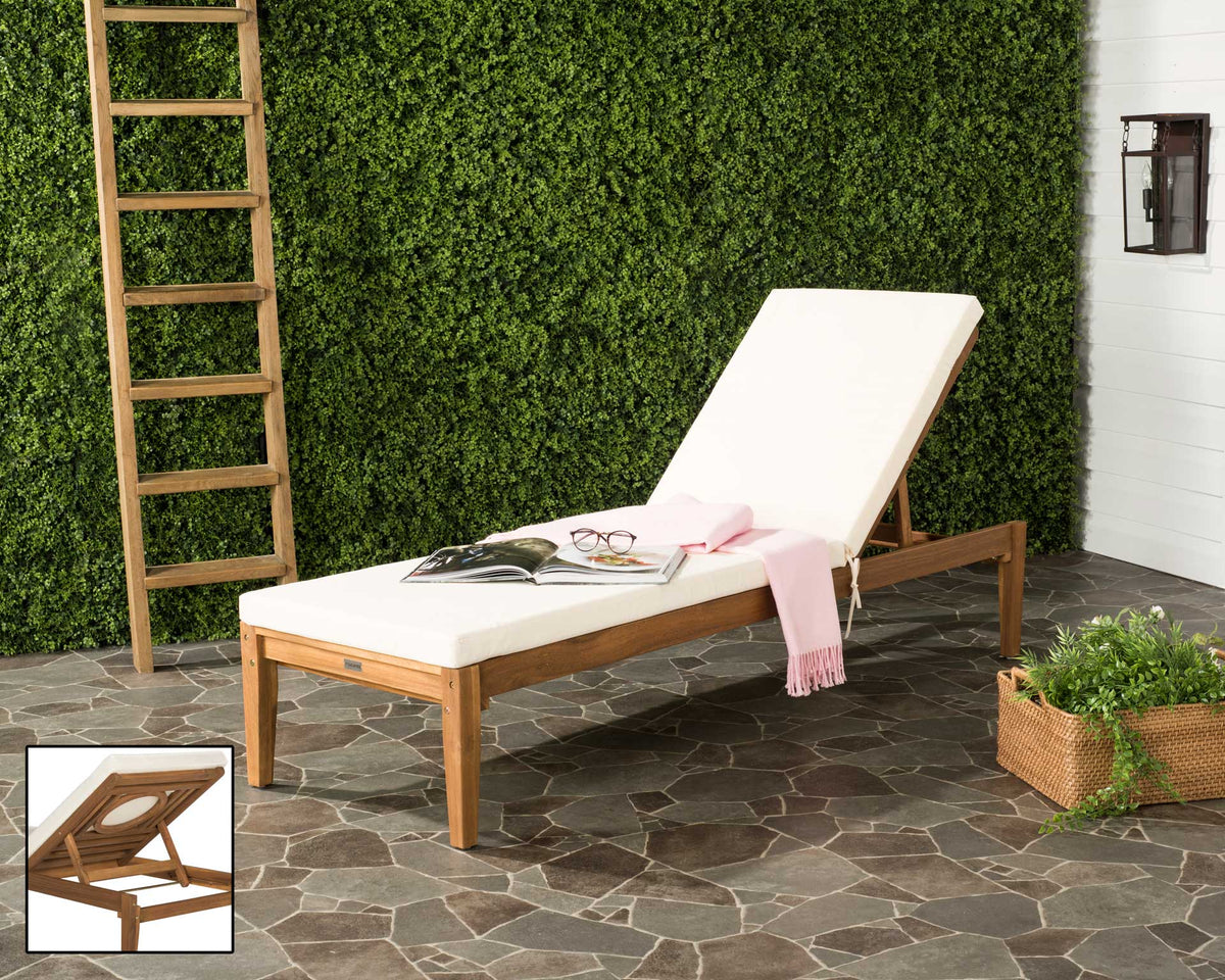 Natural acacia sun lounger adds warm wood grain and beige cushioning to a leafy outdoor retreat