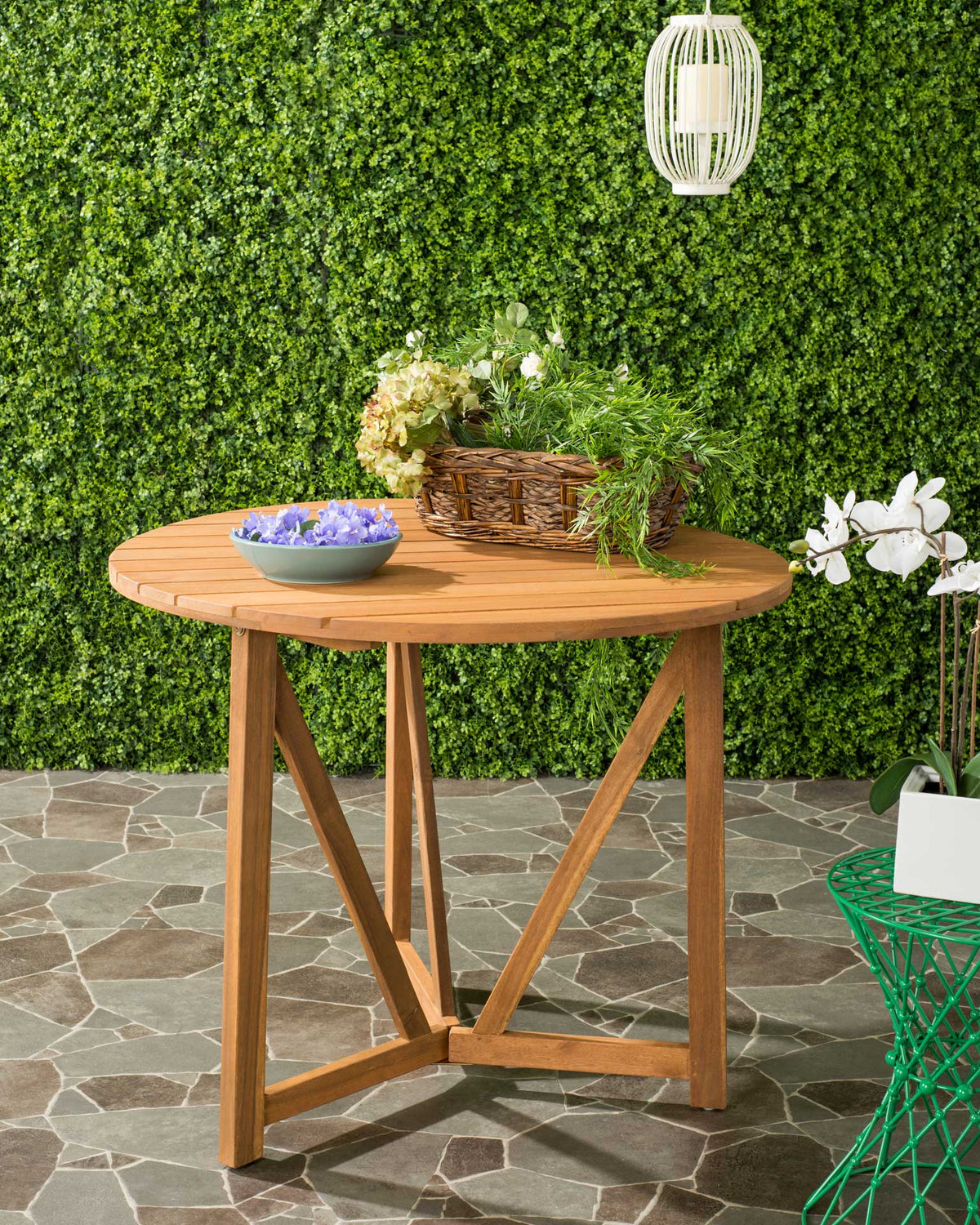 A natural acacia table adds warm wood tones and rustic style to the patio