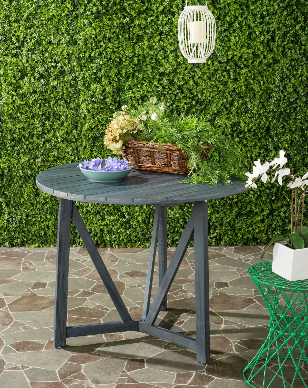 An ash gray slatted table offers space for flowers and refreshments on the patio