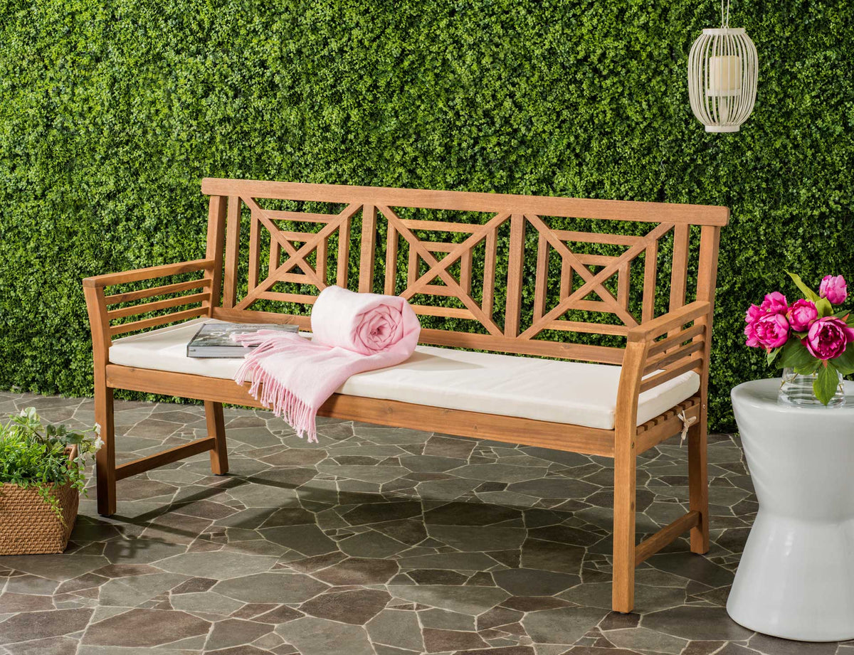 A natural wood bench pairs its airy geometric back with a beige cushion for inviting patio seating