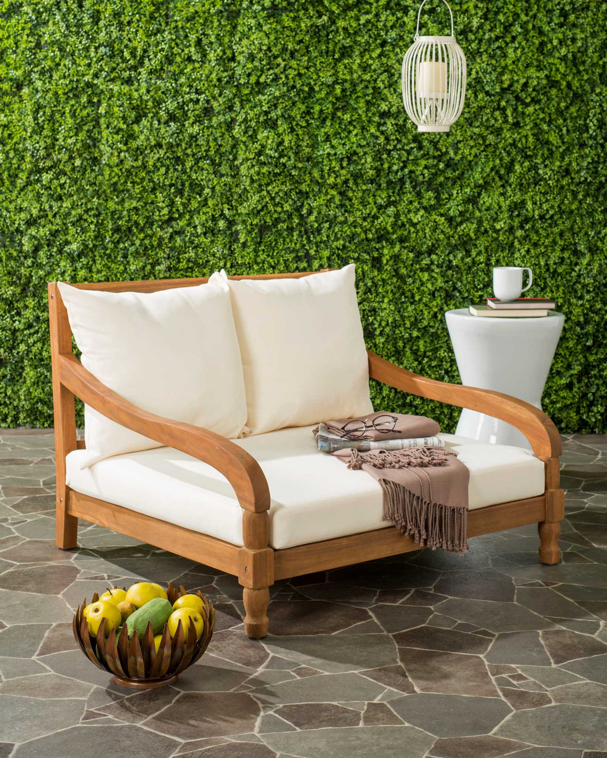 Warm natural acacia and plump beige cushions invite leisurely outdoor lounging