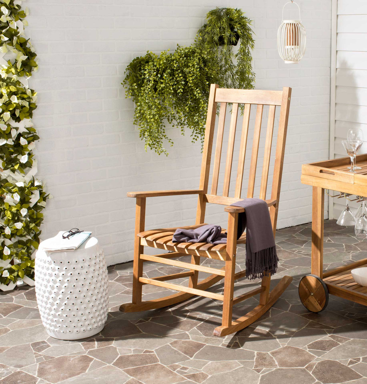 Natural wood rocking chair brings warm, rustic style to a bright outdoor patio