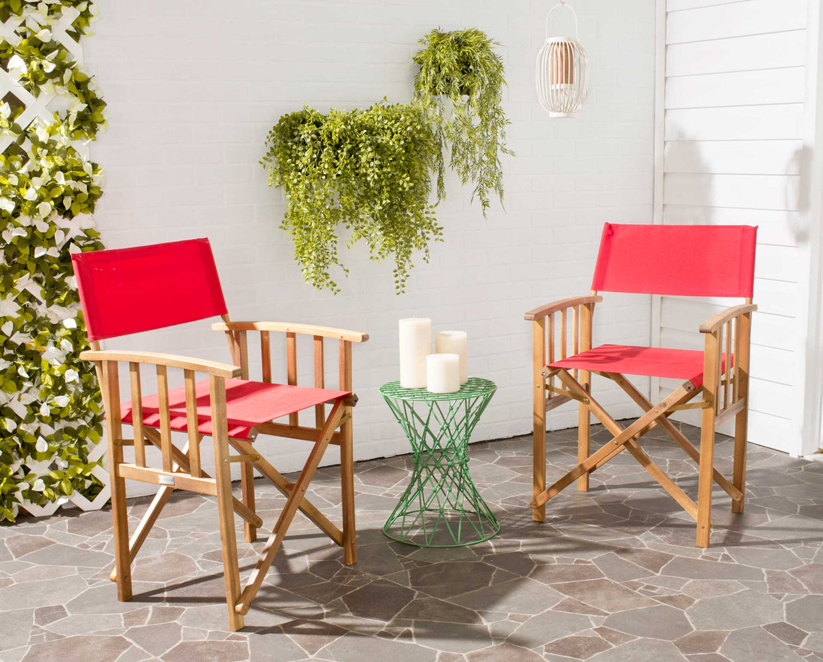A pair of red fabric and natural acacia chairs brings cheerful seating to the patio