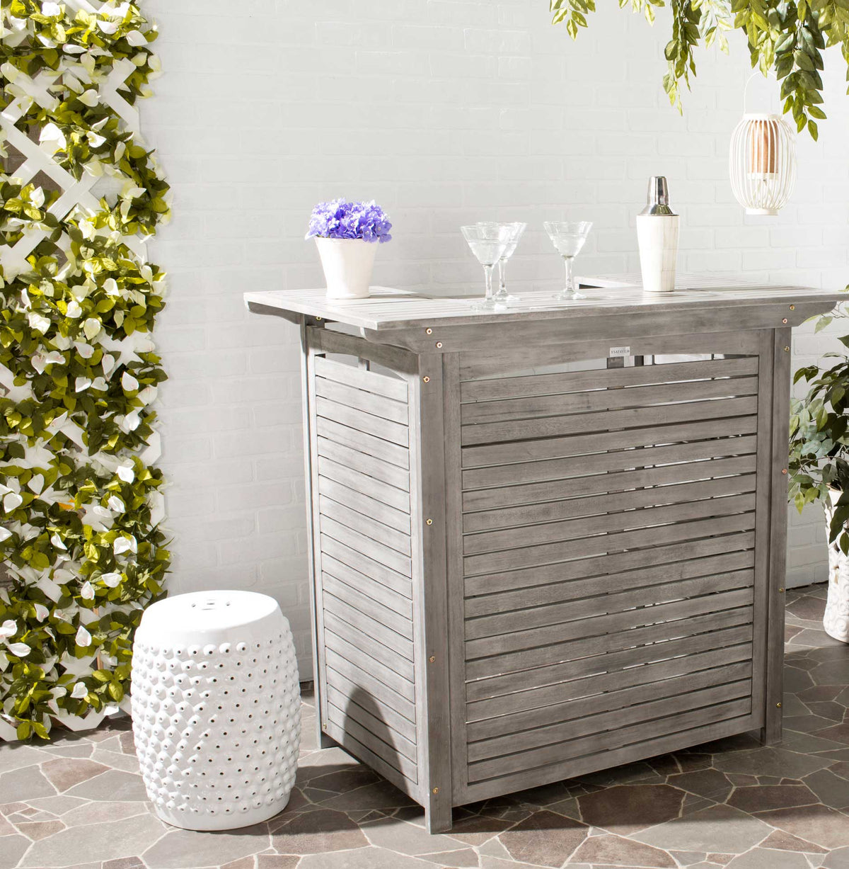 Gray slatted bar table provides a generous outdoor surface for entertaining