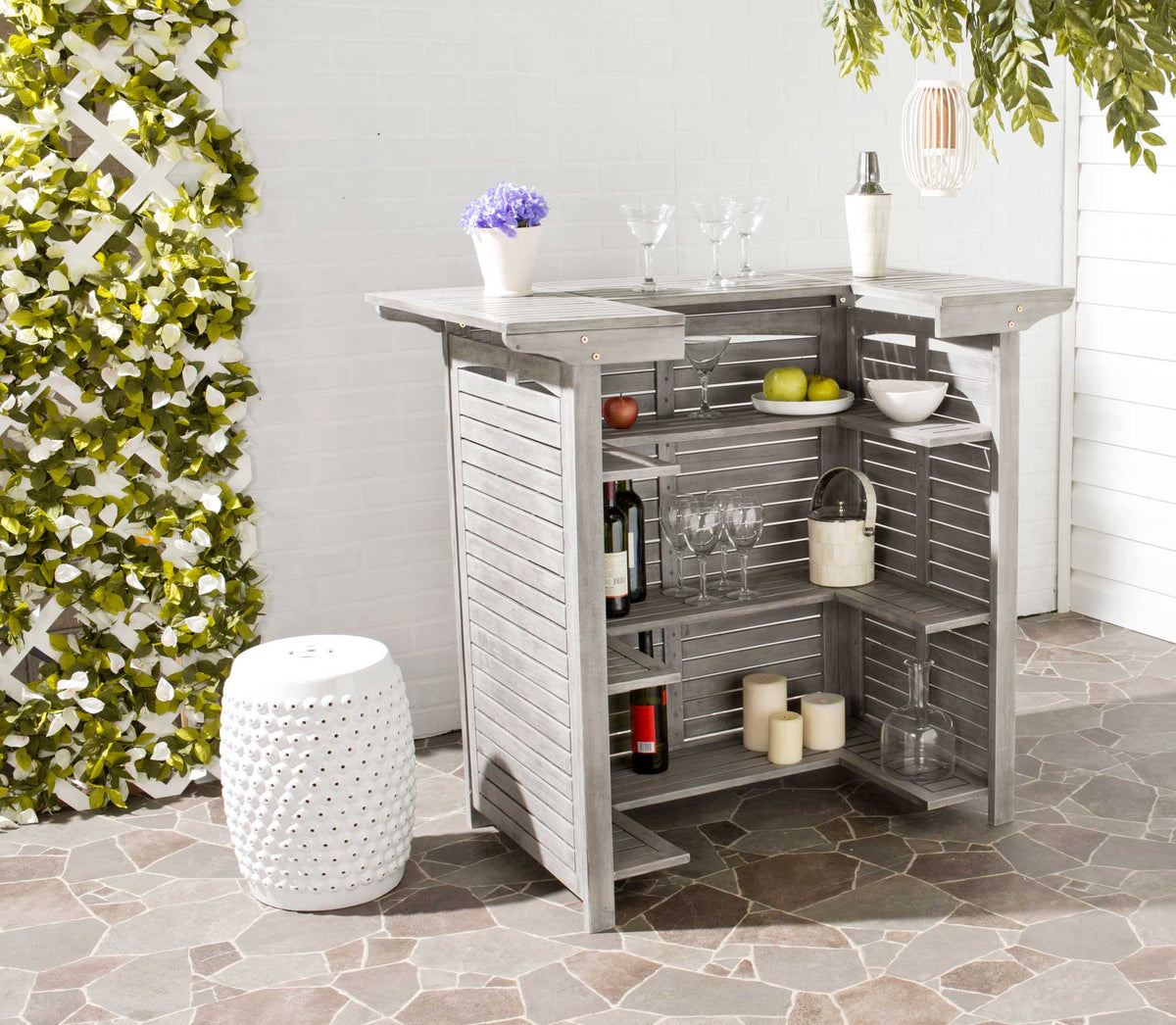 Open shelves beneath the gray bar top hold bottles, glassware and serving essentials