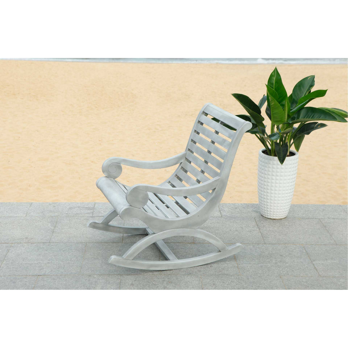 Curved rocker rails and an open slatted seat give this ash gray chair an airy outdoor feel