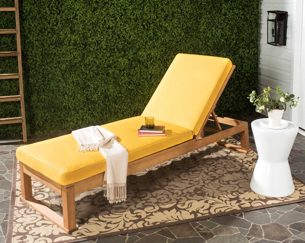 Golden yellow cushions warm up the natural wood lounger for a welcoming patio retreat.