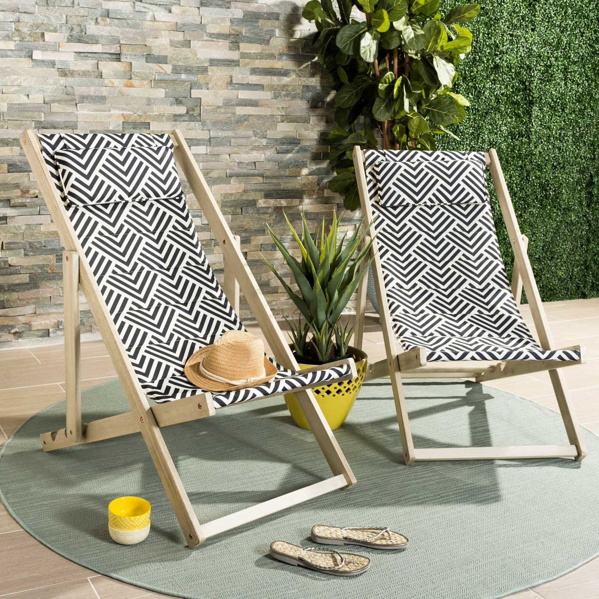 Graphic navy and white sling fabric and pale wood give outdoor seating a resort-inspired feel