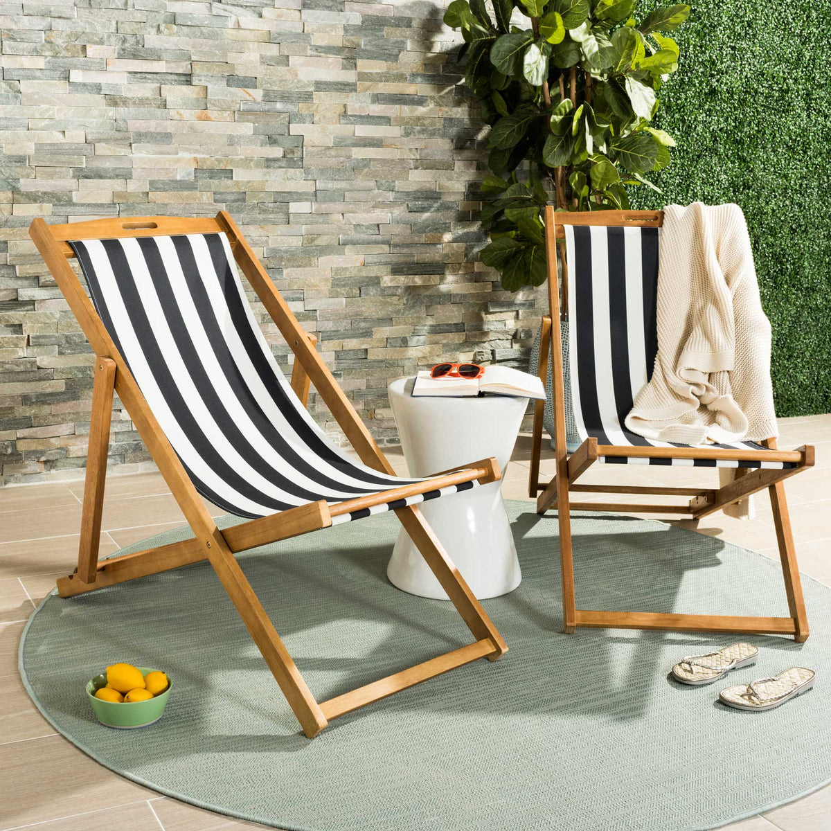 Two striped sling chairs create an inviting place to unwind on a sunny patio.
