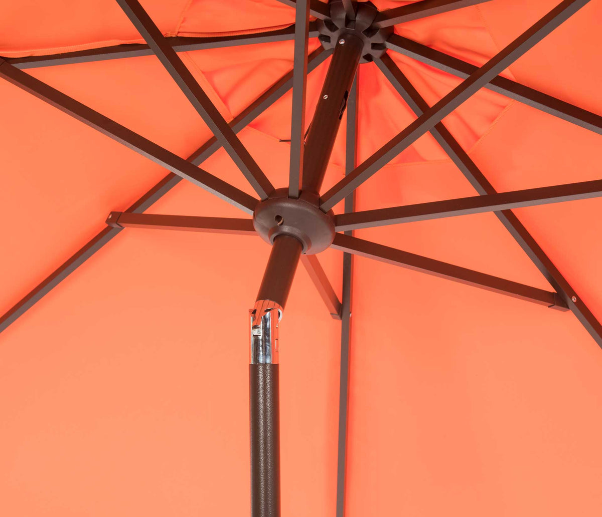 Dark radial ribs and a central hub support the vivid orange umbrella canopy
