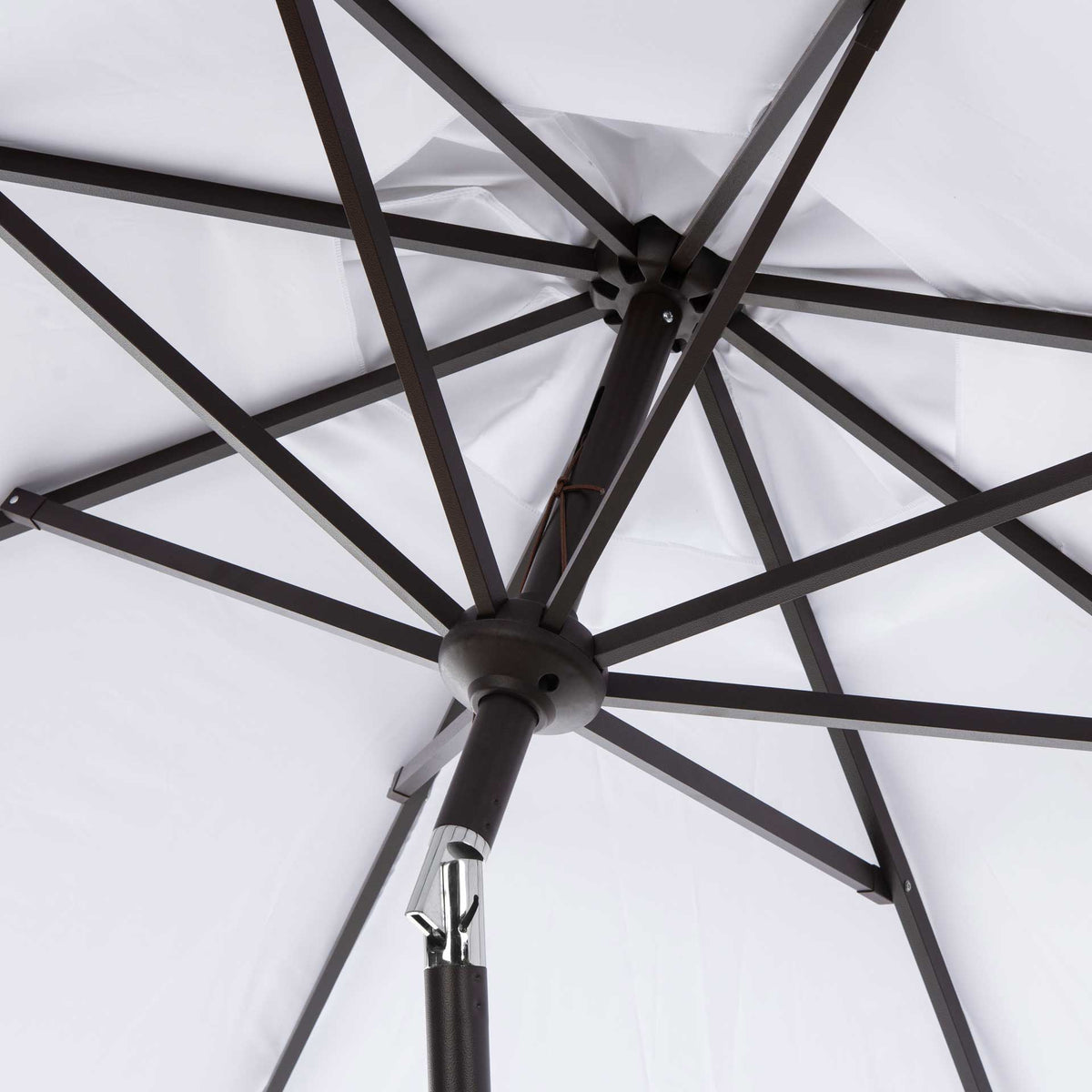 Dark aluminum ribs radiate from a central hub beneath the white canopy