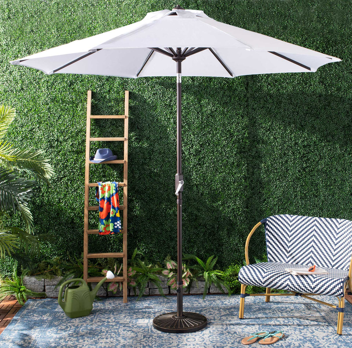 A wide white canopy shades outdoor seating beneath its sturdy dark metal pole