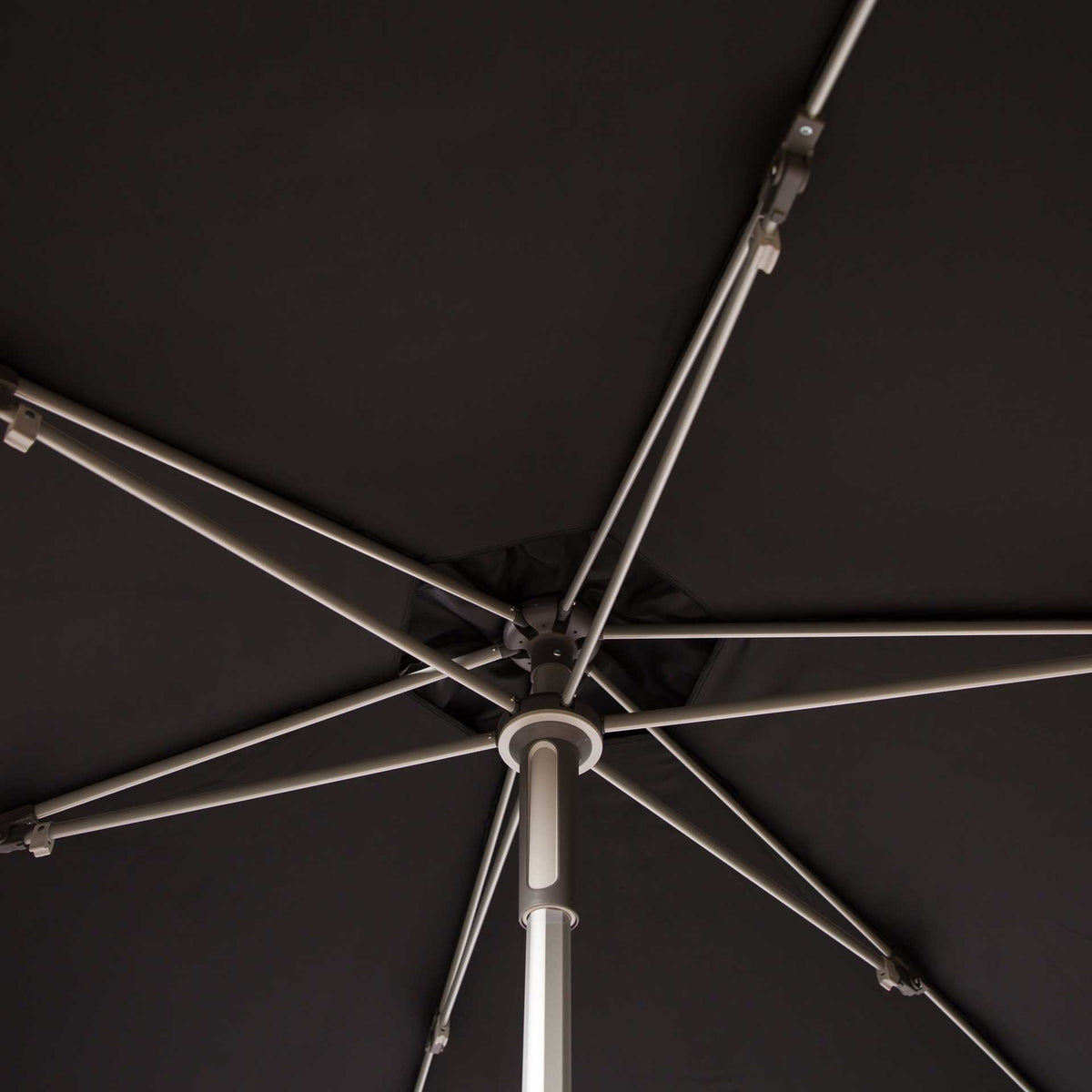 Metal ribs radiate from a central hub beneath the black canopy.